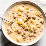 Creamy Sausage Potato Soup served in rustic bowl