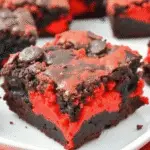 Halloween Brimstone Brownies with red cheesecake swirls served on a spooky tray
