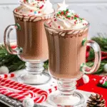 Festive peppermint hot chocolate for christmas with whipped cream and candy cane garnish
