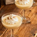 Creamy Baileys Eggnog cocktail garnished with cinnamon for the holidays.