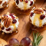 Cranberry Pecan Goat Cheese Balls with pecans, cranberries, and honey drizzle