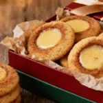 Eggnog Snickerdoodle Thumbprint Cookies featured on a rustic board with festive decor