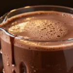 Close-up of frozen hot chocolate being blended with chocolate and milk for a thick creamy texture.