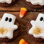 Adorable Marshmallow Ghost Cookies with candy eyes and sanding sugar.