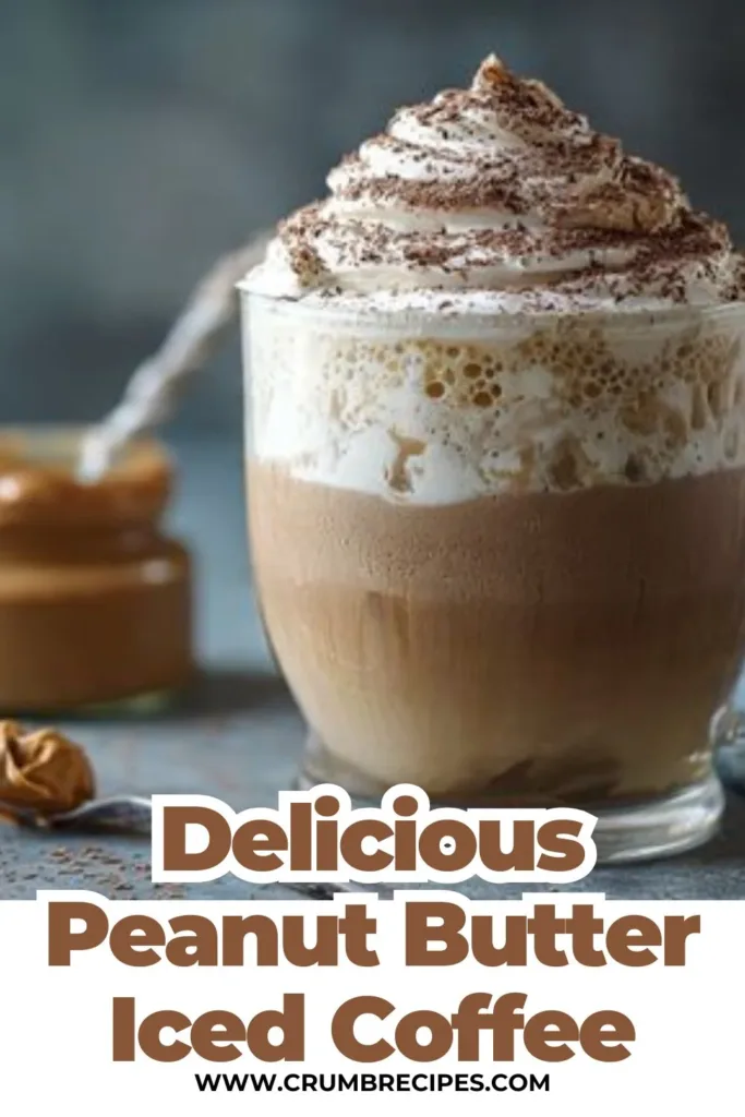 Peanut Butter Iced Coffee peanut butter iced coffee Delicious peanut butter iced coffee in a glass with ice cubes and whipped cream.