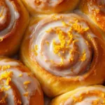 Homemade orange rolls with cinnamon glaze on a plate