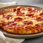 A plate of tasty Pizza Eggs with cheese, tomatoes, and herbs.