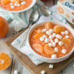 Delicious cottage cheese jello salad served in a bowl with colorful fruit
