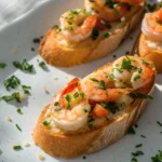 Easy baked shrimp crostini appetizer on a serving platter