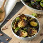 Crispy air-fried Brussels sprouts in a bowl with herbs and seasoning.