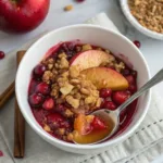 Delicious cranberry apple crisp dessert topped with crunchy oats and served warm.